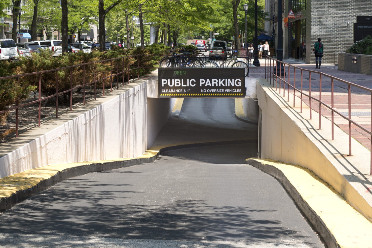 Tree-lined ramp leading down to the Orrington Plaza public parking garage